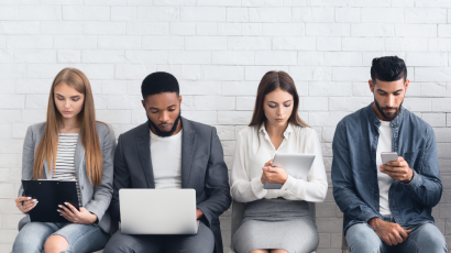 Four people (two women and two men) are sitting and waiting for the interview