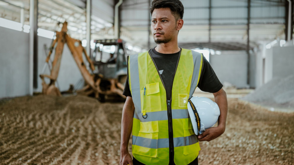 Latin American male industrial worker holding a helmet