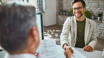 A young worker starting their first job, standing confidently in a workplace