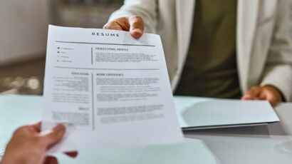 A close up of a printed resume on a desk before it is screened